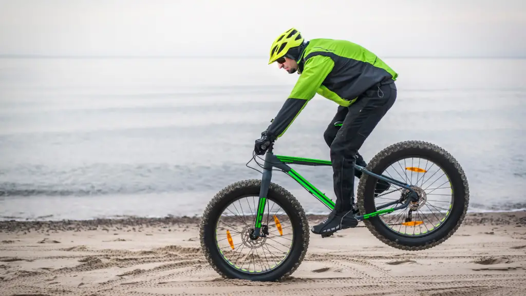 Rider doing a nose manual with a fat bike