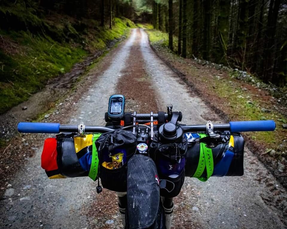 touring bike with baryak handlebar extender riding a trail