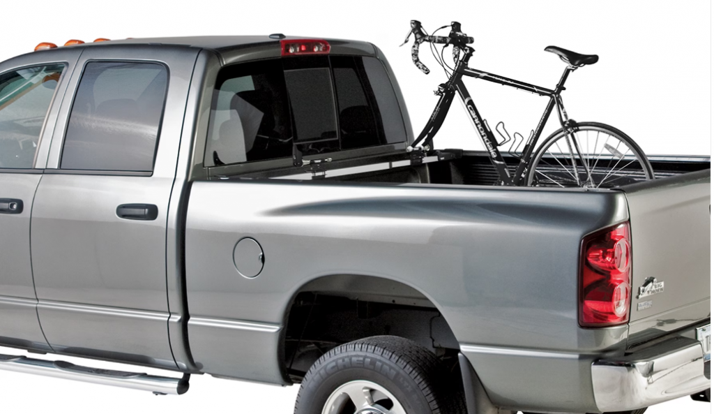 Installed thule bike rack in a grey truck bed with a bike mounted
