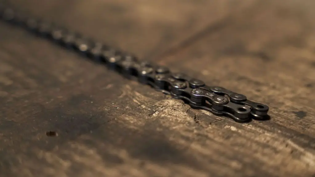 2 bike chains laid side by side on a wooden table