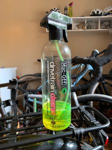 Bottle of bike chain degreaser on a rear bike rack