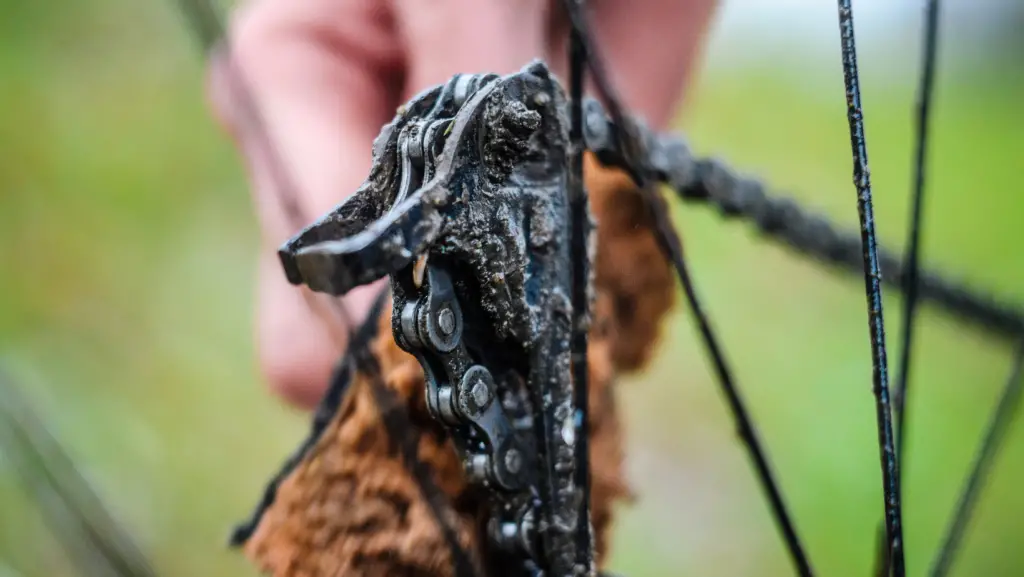 man cleaning really dirty bike chain and sprocket