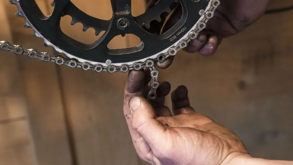 Man trying to determine the size of his new chain 
