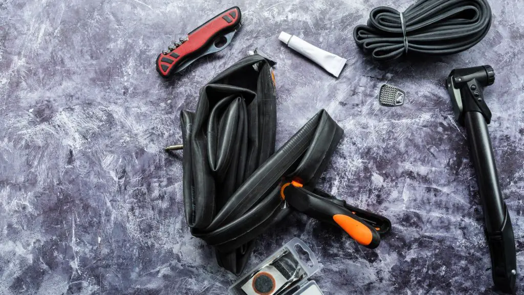 Tools used to repair a bike inner tube on a table