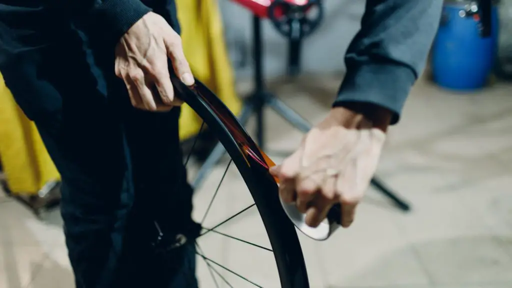 Man replacing the rim tape of a tubeless tire