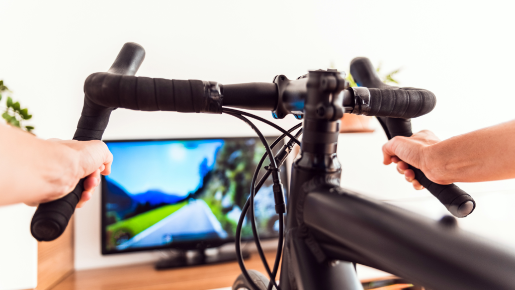Bike handlebar with a tv screen in the background